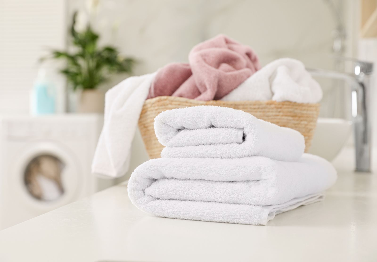 Stack of soft folded white towels washed in conditioned water