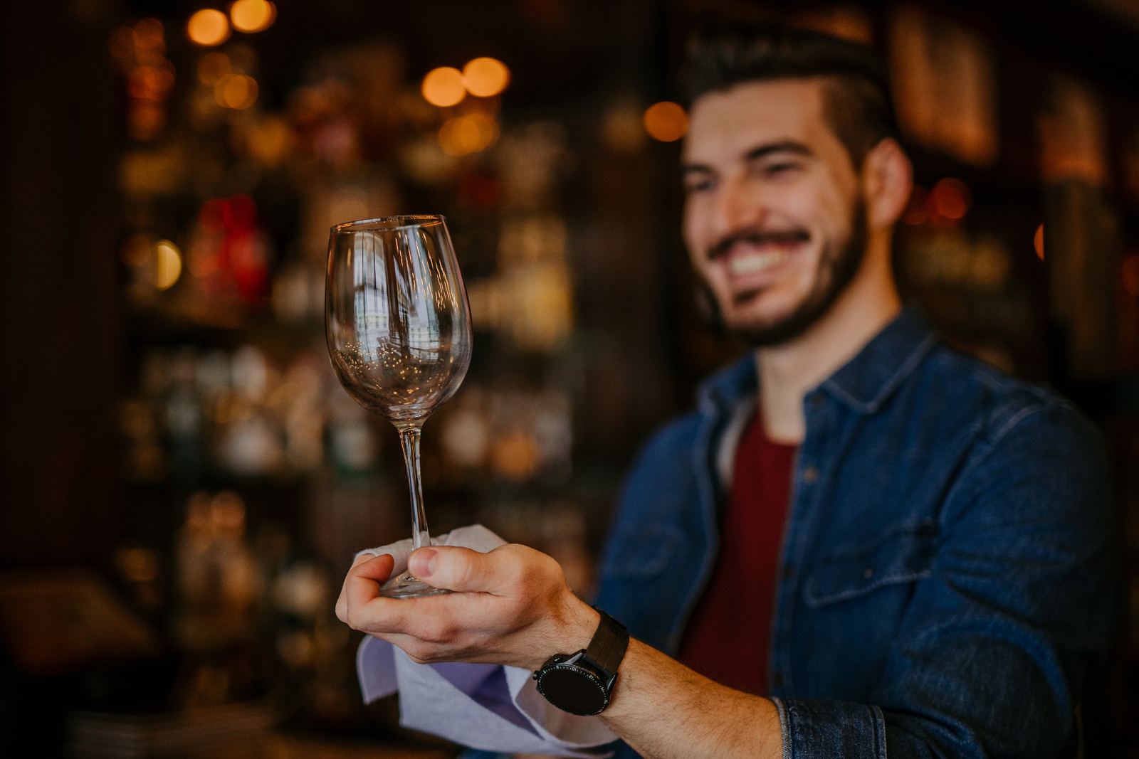 Person inspecting a spotless sparkling wine glass